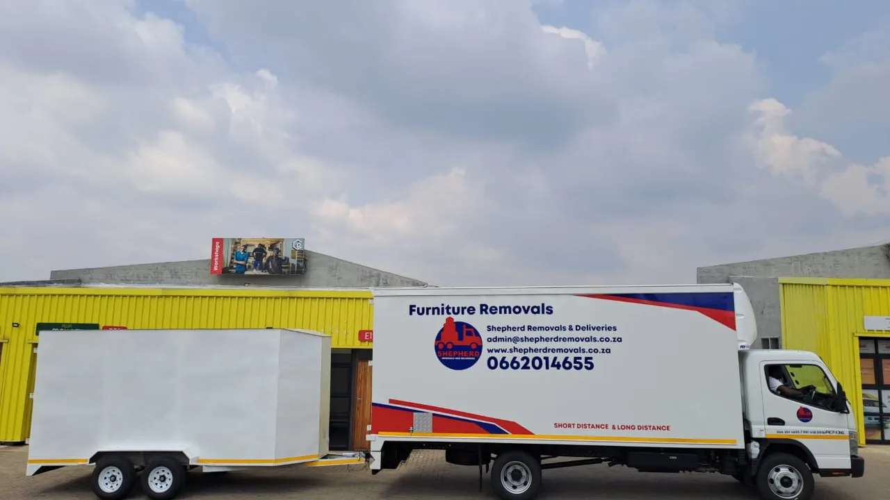Shepherd Removals branded truck and trailers at the depot